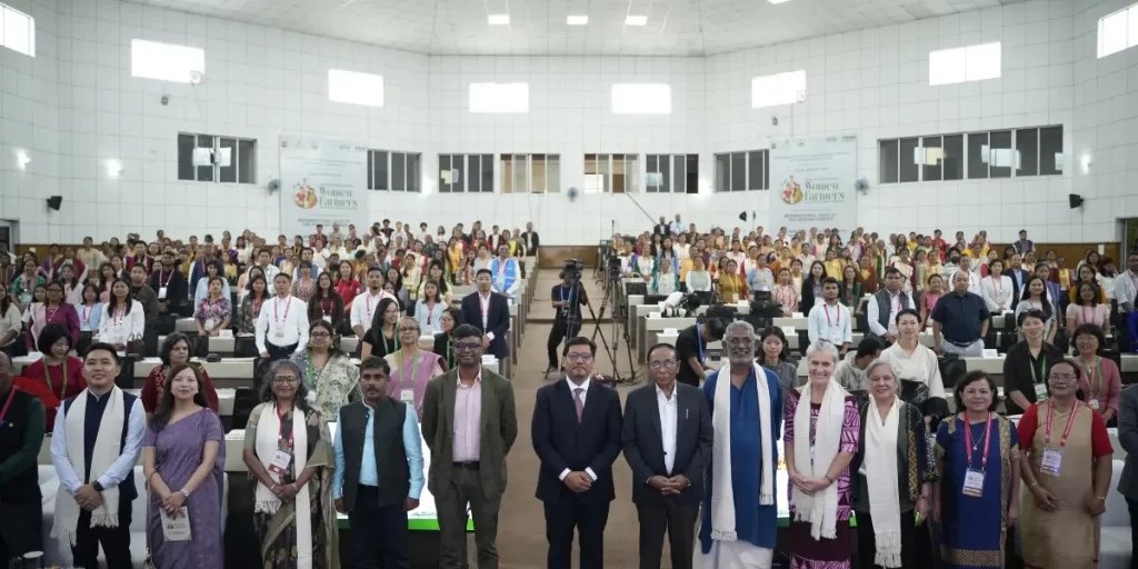 Delegates and Participants of the International Conference on Women Farmers and Organic Food Systems posing for a photo in the main auditorium